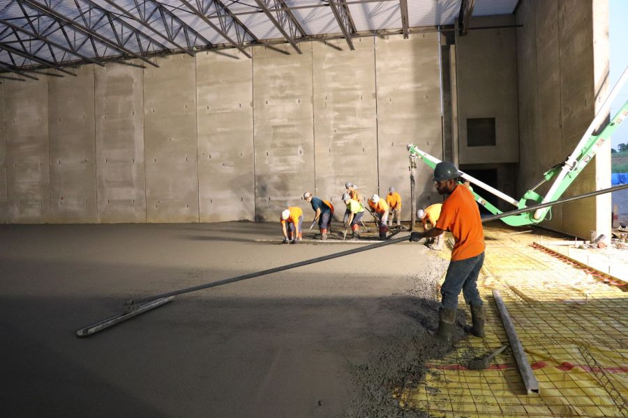 concrete contractors pouring structural concrete on wire mesh