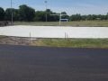 freshly paved asphalt and concrete at Wellsville High School