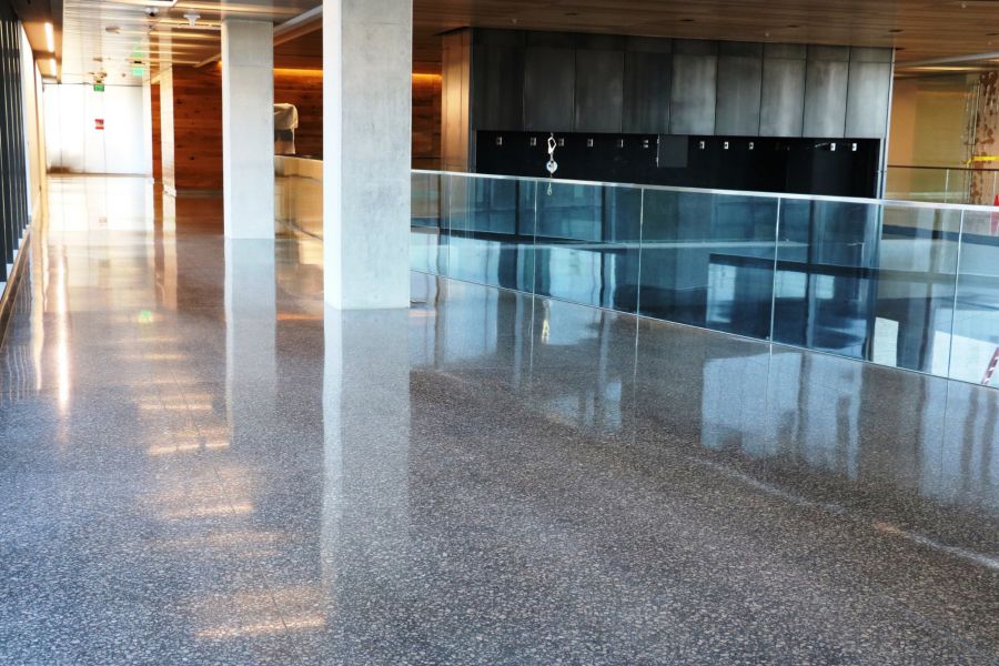 decorative concrete flooring featuring glass railing