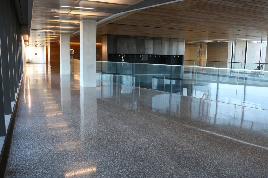 glass railing and speckled decorative concrete inside Cerner