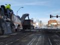 asphalt contractors reconstructing 20th street by utilizing big trucks and machines