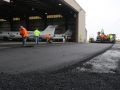 asphalt contractors with various tools to help smooth out the asphalts