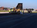 asphalt contractors pouring asphalt paving onto the New Century Airport Takeoff Area