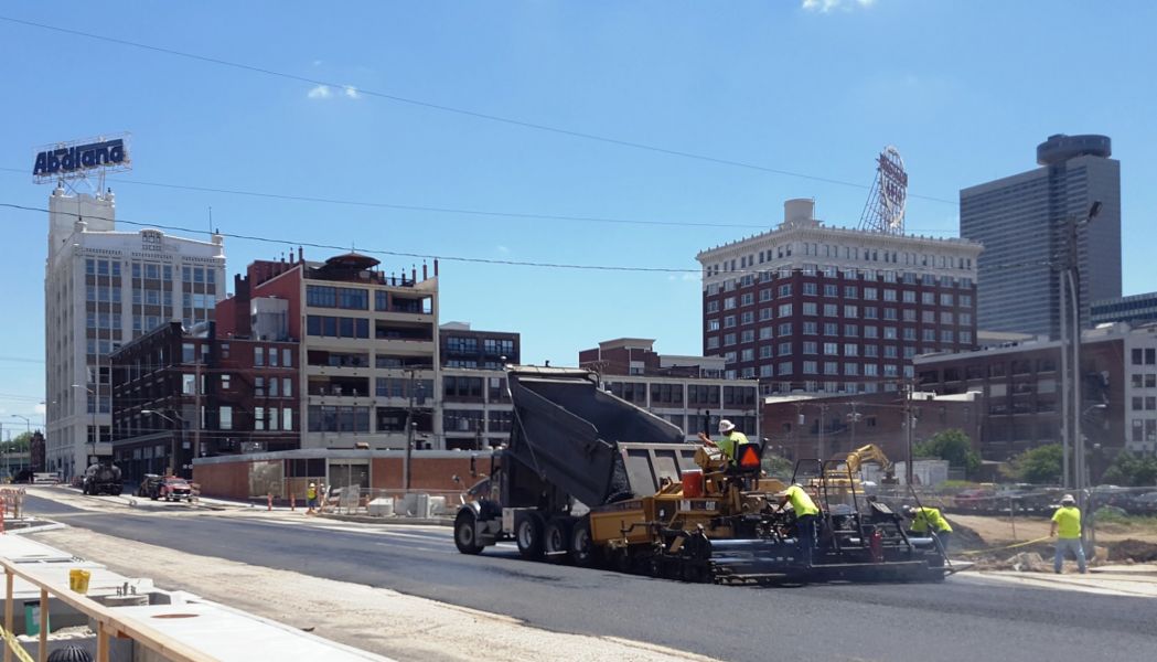 asphalt contractor pouring hot asphalt on 20th street in the Crossroads District