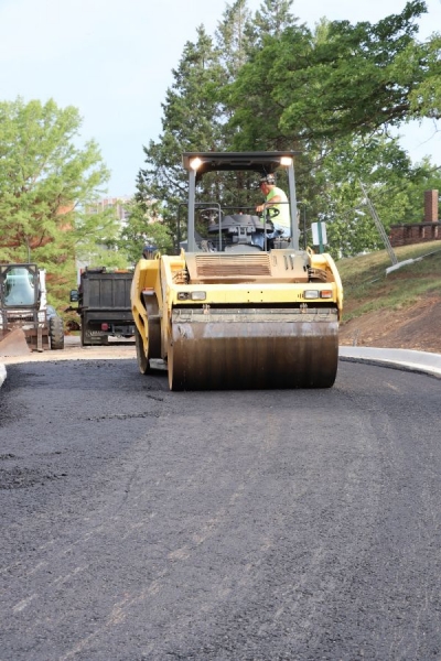 a asphalt roller smoothing out the asphalt paving