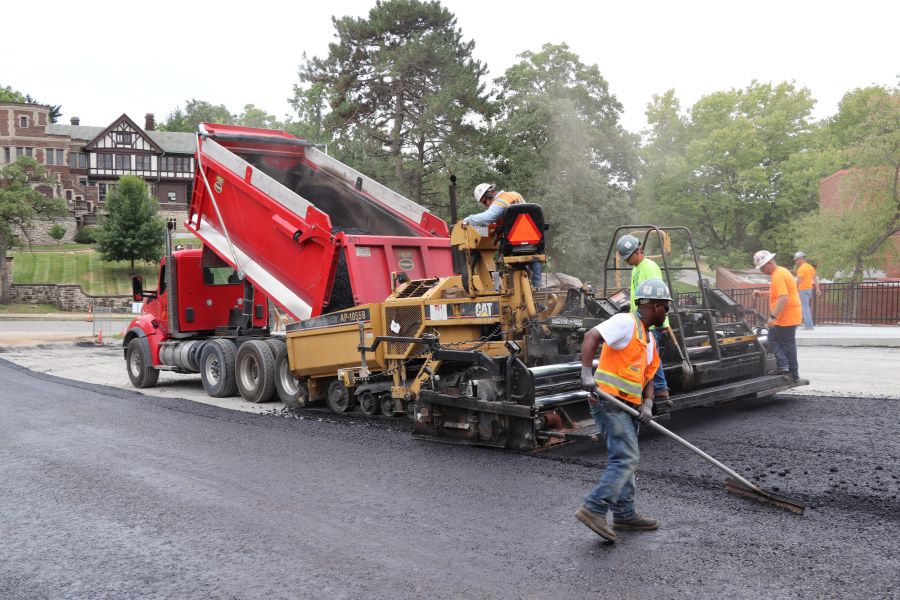 asphalt contractors pouring hot asphalt onto a road at UMKC