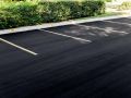 new freshly laid asphalt parking lot with brand new parking lines