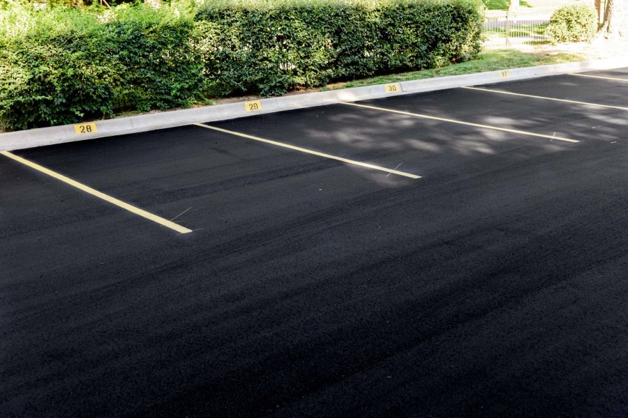 new freshly laid asphalt parking lot with brand new parking lines